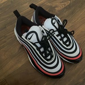 The color of the shoe is black red and white.